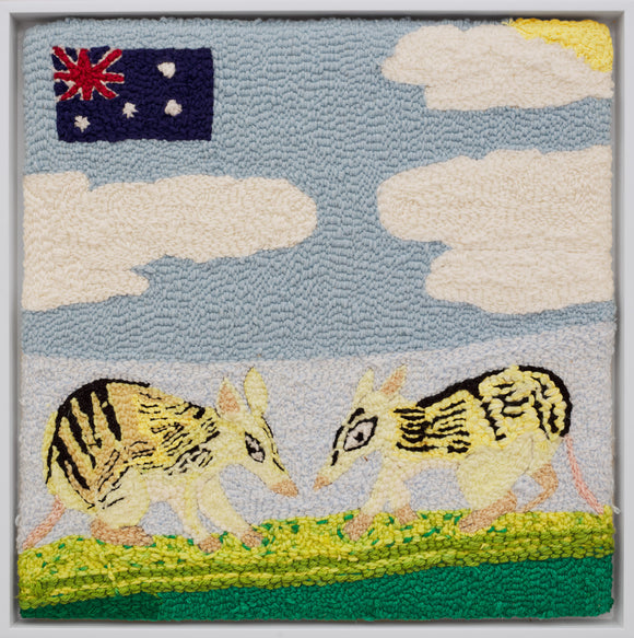‘Fun Facts About Bandicoots’ measures 20 by 20in. It’s a yarn on monk’s cloth piece that features two bandicoots facing each other with partly cloudy blue skies and the Australian flag in the upper left corner. The bandicoots are a light yellow in color and have black and brown markings on their bodies. In the upper right hand corner the yellow sun pokes out from behind a white cloud.