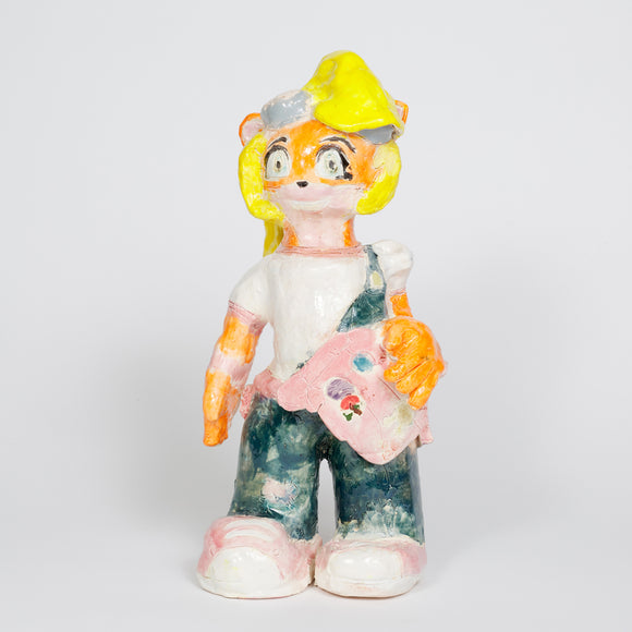 ‘Coco Bandicoot’s 25th Anniversary’ is a glazed ceramic piece by Catalina Ortega. It measures 15 by 7 by 7in. The subject of the piece, Coco Bandicoot, is the little sister of the main protagonist, Crash Bandicoot, from the Crash Bandicoot video game series. In this artist’s rendition, Coco is wearing a pink shoulder bag, with matching color shoes. Her signature outfit is represented by her white t-shirt and blue overalls. 