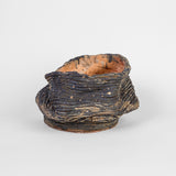 Continuous Touch by Ericka Lopez features 21 coiled ceramic vessels in a variety of sizes and colors. Ranging from bright, fiery red to cool, deep purple, the highly tactile works are glazed with both matte and glossy finishes. While each is unique, this body of work is unified by organic, flowing contours that render distinct silhouettes on all sides of the pieces. The artist encourages you to touch lightly for the most comprehensive experience.