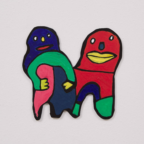 This 8 ½ by 7 ½ by 1/4th-inch wood sculpture by Hugo Rocha features two abstract, cartoon-like figures joined together. The figure on the left is painted in dark blue, green, and pink, with yellow hands and a friendly cartoonish expression. The right figure is red with a large yellow mouth, green legs, and black accents. The figures appear intertwined, creating a sense of connection and interaction. The bright, bold colors and playful design reflect Rocha's distinctive graphic artistic style.