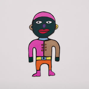 This 11 by 22 by 1/4th-inch wood sculpture by Hugo Rocha depicts a colorful, abstract human figure. The face is painted deep green with large, expressive eyes, red lips, and pink hair. The figure's shirt is split into two halves: the left side is pink and the right side is brown, both with small orange buttons. The lower half features bright orange pants with a yellow belt and pink shoes.