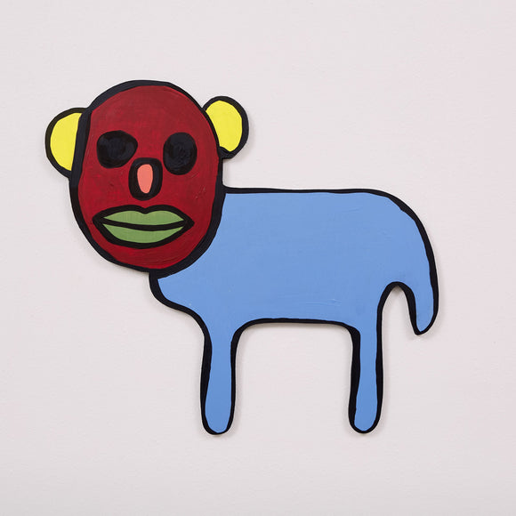 This 19 by 21 by ½-inch wood sculpture by Hugo Rocha features a quirky, abstract animal with a red face and a blue body. The face has large black eyes, a small pink nose, and green lips, outlined in black for emphasis. Yellow, round ears stand out on either side of the face. The simple, solid blue body has two legs, and the entire figure is outlined in black, giving it a cartoon-like appearance.