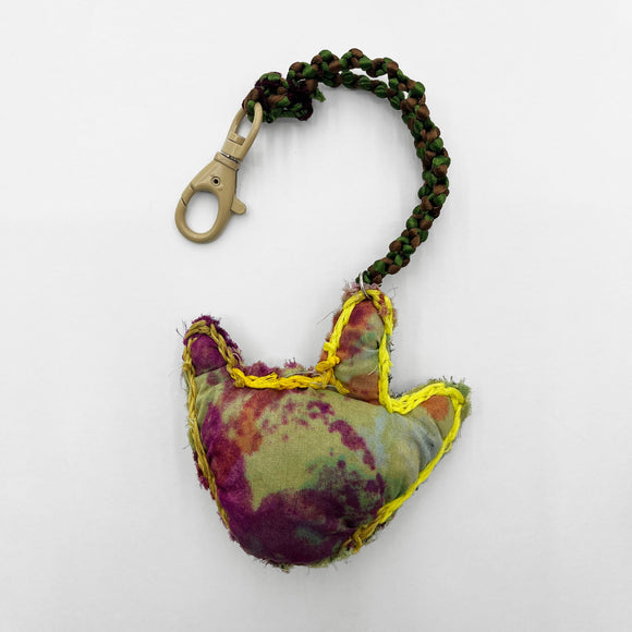 This work is one of three hand-made key-chains that say “I love you” in sign language. This key chain is embroidered with black thread and is made from floral black and white fabric. 