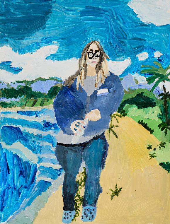 A woman in oversized glasses and a blue coat walks along a tropical shoreline. The turquoise surf churns beside her under swirling clouds and lush vegetation.