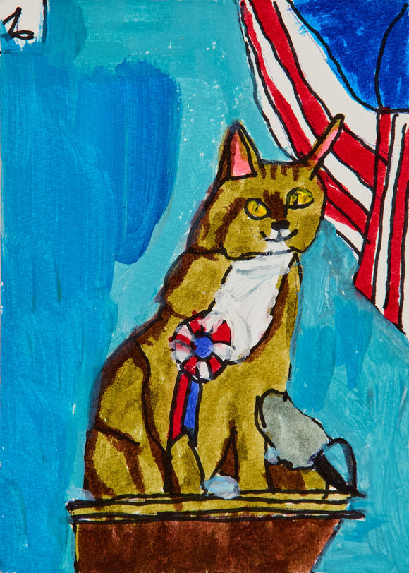 A proud tabby cat sits atop a podium, draped in red, white, and blue. A patriotic ribbon pinned to its chest and a striped banner behind it celebrate feline elegance and perhaps an award-winning moment.
