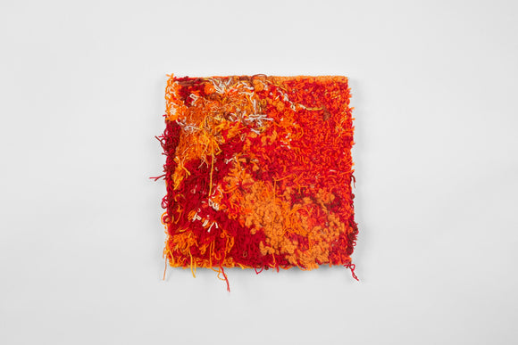 This is a sixteen-inch square, punch-rug textile made by hand using a variety of textured cotton yarn in shades of bright orange, white, and dark, fiery red. Threads protrude from the surface of the work and overhang its borders, it is mounted on stretcher bars and hung on the wall. This work did not end up making it into the final installation for the exhibition, but is still available for purchase. 